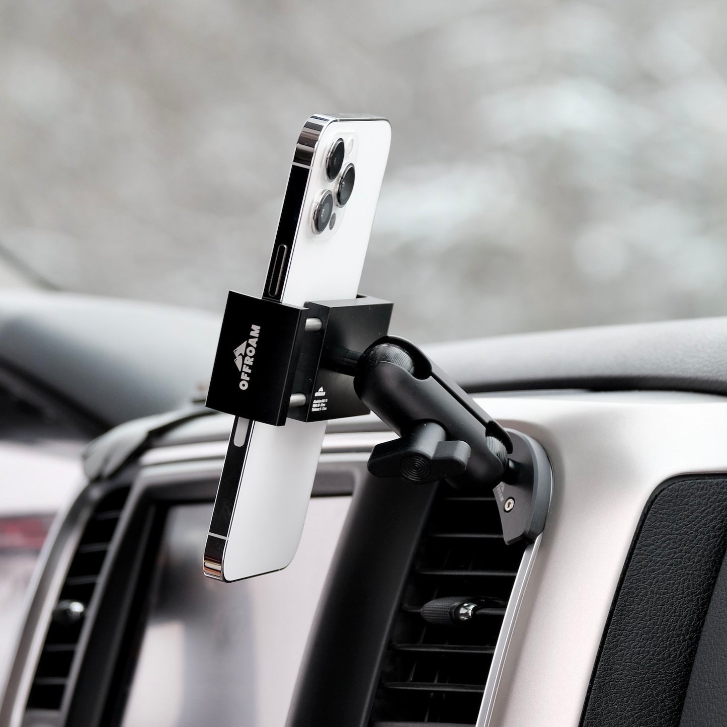 Image of Offroam Phone Mount installed securely in Ram 1500/2500/3500 2013-2018 & Ram Classic 2019-2024. This premium phone mount installs easily without drilling or glue. Spring loaded Universal holder for use with any phone. Perfect placement without blocking screens, driver view, or air flow. Fully adjustable positioning.