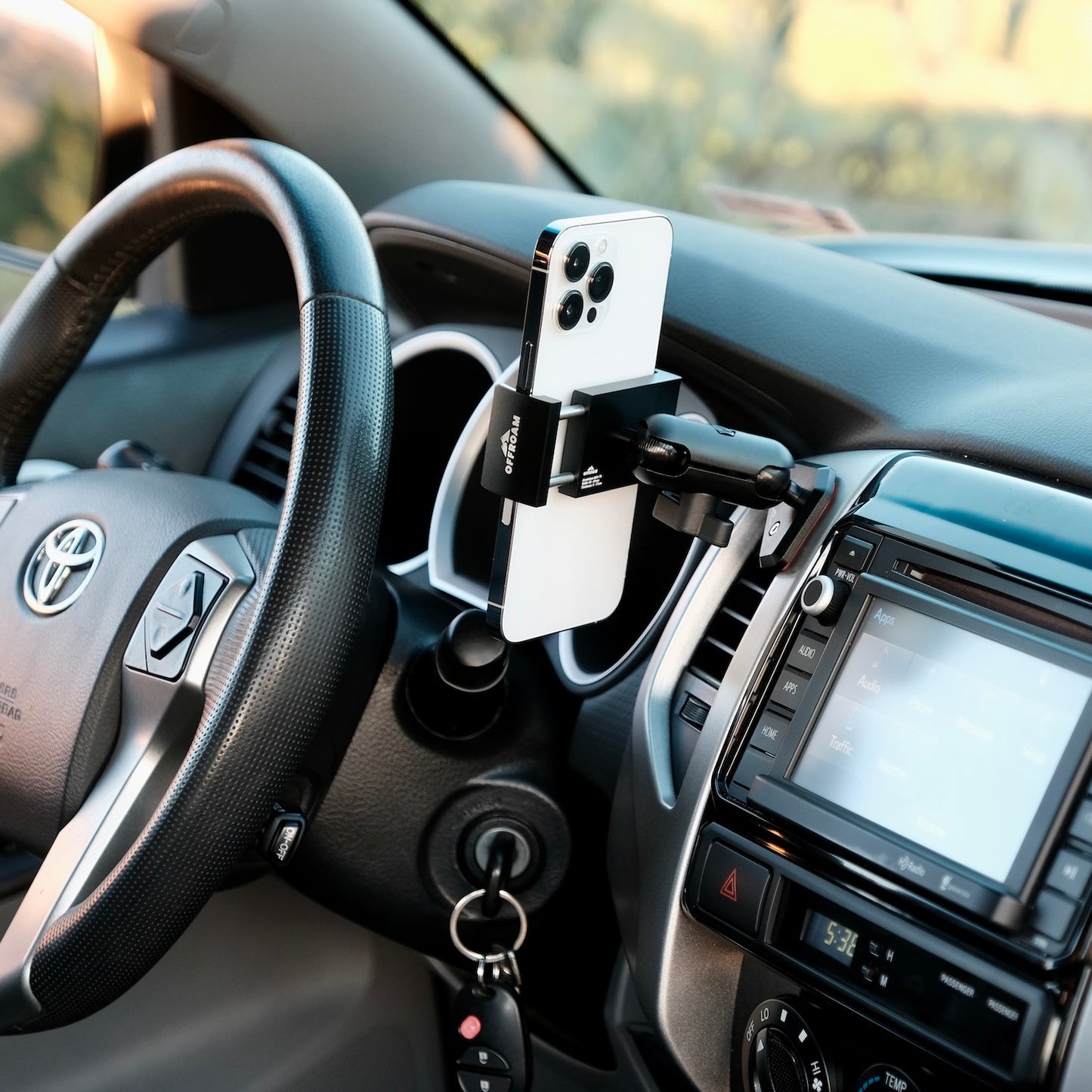 Image of Offroam Phone Mount installed securely in Toyota Tacoma 2012-2015. This premium phone mount installs easily without drilling or glue. Spring loaded Universal holder for use with any phone. Perfect placement without blocking screens, driver view, or air flow. Fully adjustable positioning.