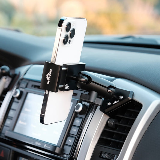 Image of Offroam Phone Mount installed securely in Toyota Tacoma 2012-2015. This premium phone mount installs easily without drilling or glue. Spring loaded Universal holder for use with any phone. Perfect placement without blocking screens, driver view, or air flow. Fully adjustable positioning.