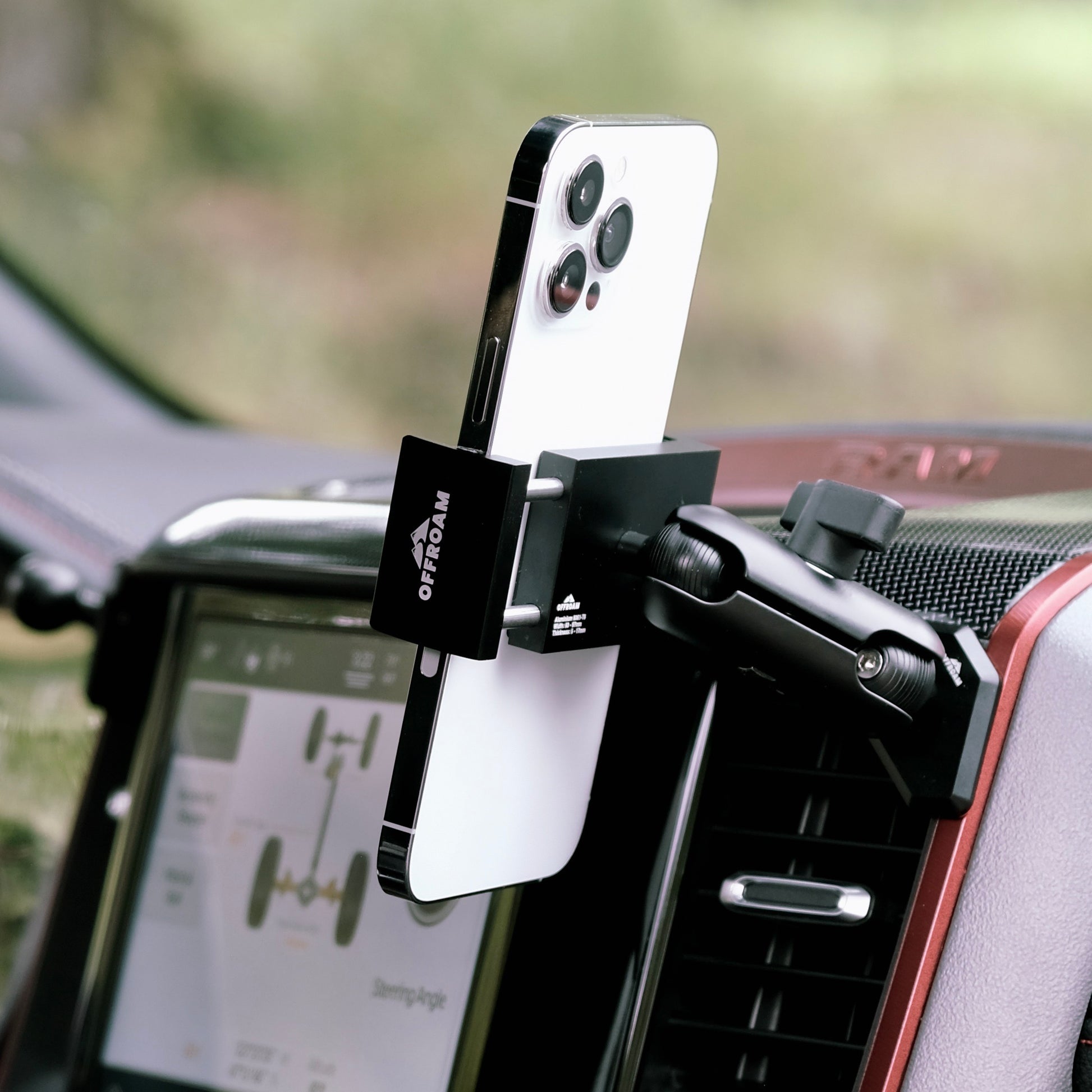 Image of Offroam Phone Mount installed securely in Ram 1500/2500/3500 2019-2025. This premium phone mount installs easily without drilling or glue. Spring loaded Universal holder for use with any phone. Perfect placement without blocking screens, driver view, or air flow. Fully adjustable positioning.