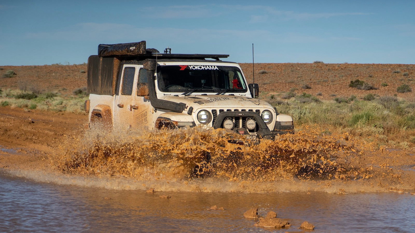 Image of snorkel-equipped Jeep Wrangler driving through deep water.