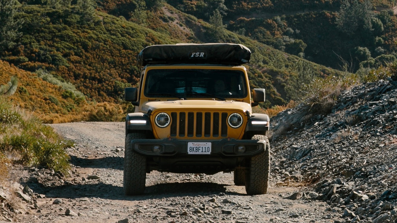 Image of Jeep Wrangler 2018-2023 heading down a gravel road with sturdy Offroam 4x4 phone mount installed that holds navigation devices off-road.