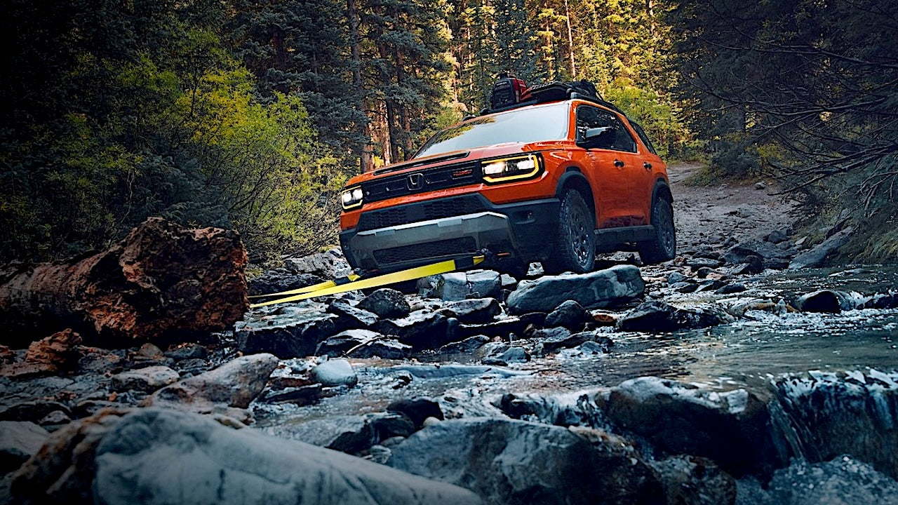Image of Honda Passport 2026 clearing a tree from a river crossing.
