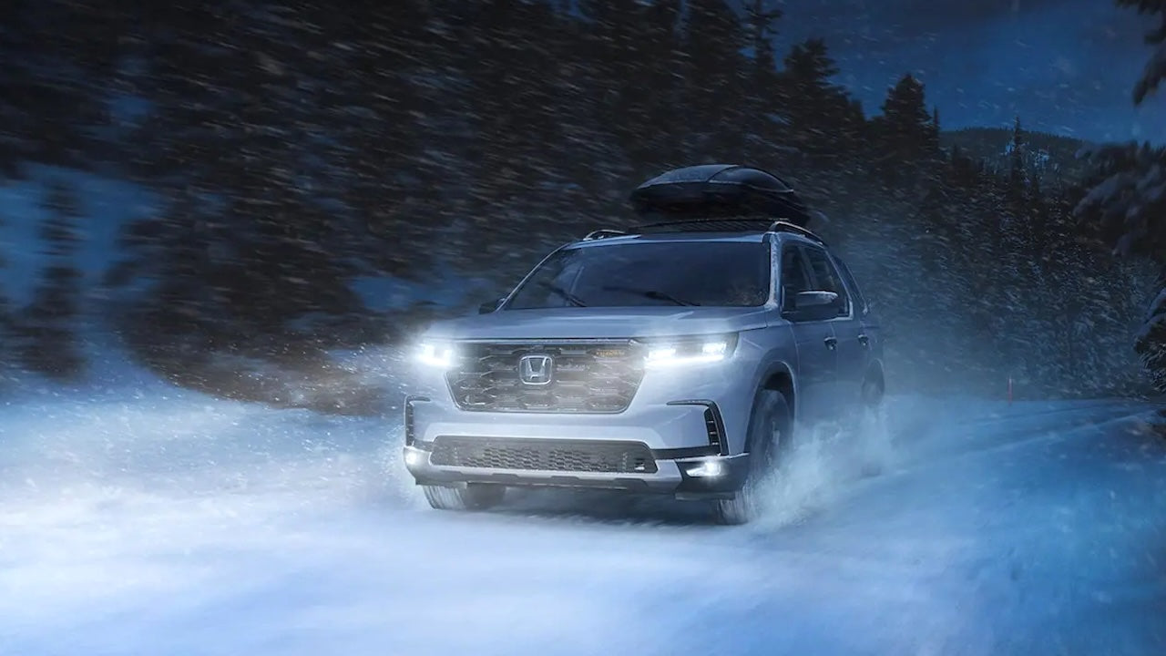 Image of Honda Pilot 2024-2025 at night on a snowy road.