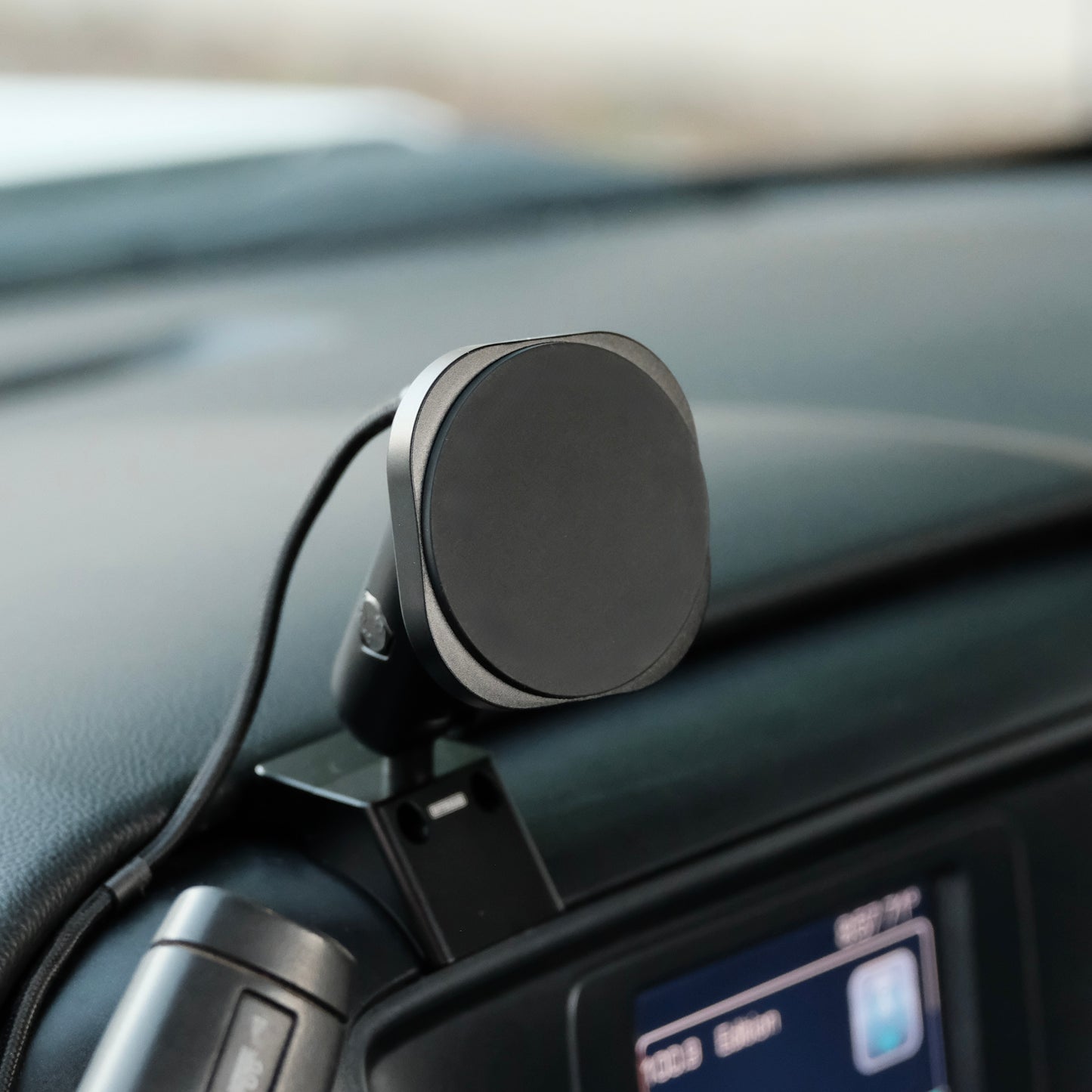 Image of Offroam MagSafe-compatible Phone Mount installed securely in Chevrolet Silverado 1500 2014-2018 | Silverado HD 2500/3500 2015-2019 | Silverado HD 4500/5500/6500 2019-2026 | GMC Sierra 1500 2014-2018 | Sierra HD 2500/3500 2015-2019. This premium phone mount installs easily without drilling or glue. High force magnets hold phone on any trail, road, or track. Perfect placement without blocking screens, driver view, or air flow. Fully adjustable positioning.