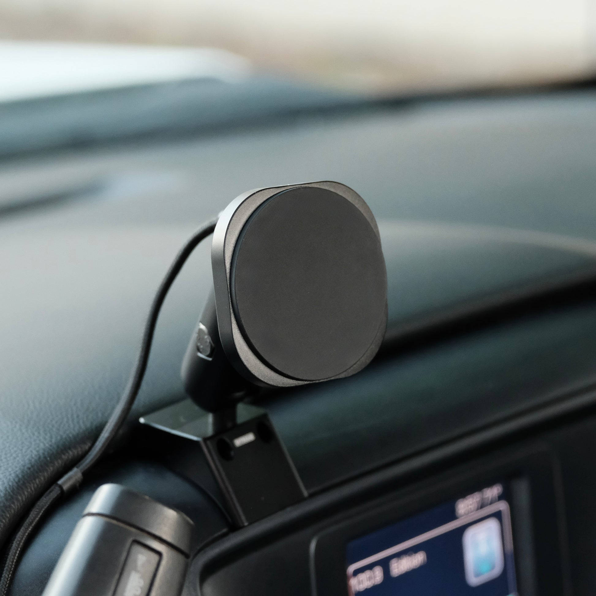 Image of Offroam MagSafe-compatible Phone Mount installed securely in Chevrolet Silverado 1500 2014-2018 | Silverado HD 2500/3500 2015-2019 | Silverado HD 4500/5500/6500 2019-2026 | GMC Sierra 1500 2014-2018 | Sierra HD 2500/3500 2015-2019. This premium phone mount installs easily without drilling or glue. High force magnets hold phone on any trail, road, or track. Perfect placement without blocking screens, driver view, or air flow. Fully adjustable positioning.