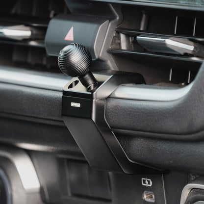 Image of Offroam Mounting Base installed securely in Toyota Grand Highlander 2024-2026. This premium all metal phone mounting base installs easily without drilling or glue. Perfect placement without blocking screens, driver view, or air flow.