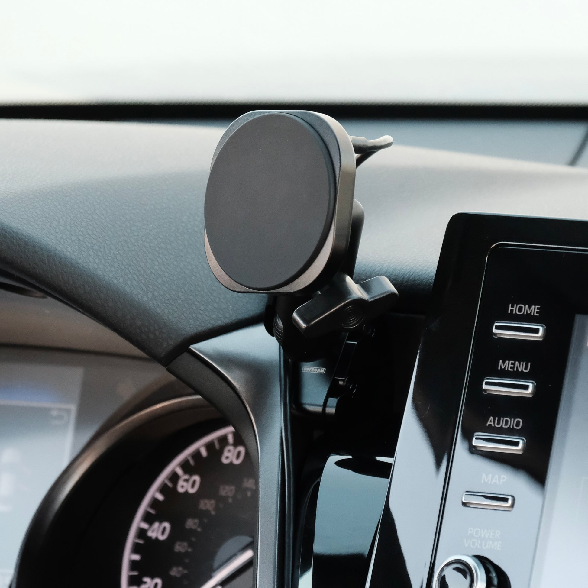 Image of Offroam MagSafe-compatible Phone Mount installed securely in Toyota Camry 2021-2024. This premium phone mount installs easily without drilling or glue. High force magnets hold phone on any trail, road, or track. Perfect placement without blocking screens, driver view, or air flow. Fully adjustable positioning.