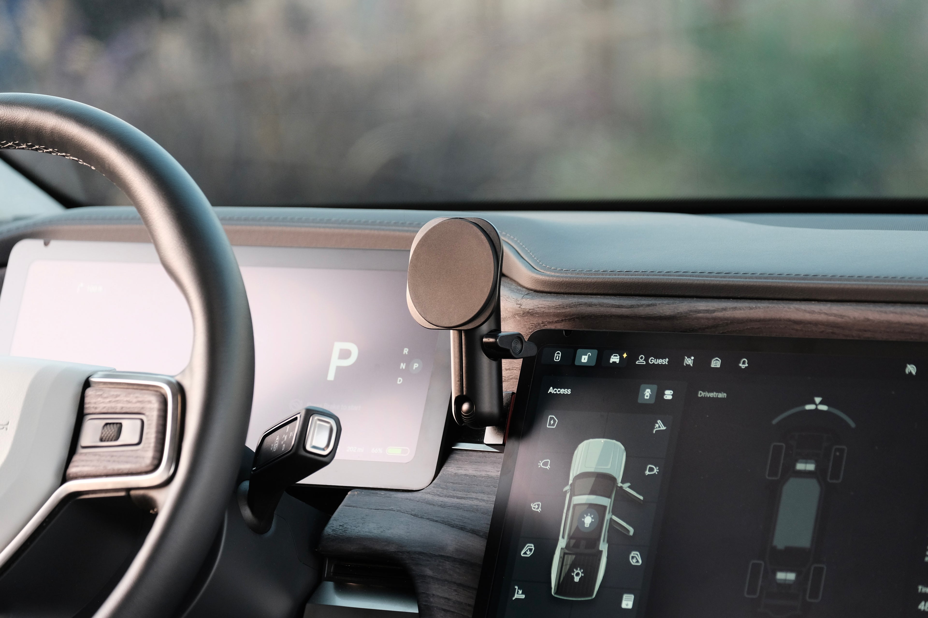 Car interior with steering wheel and digital dashboard display and MagSafe non-charging phone holder installed securely.