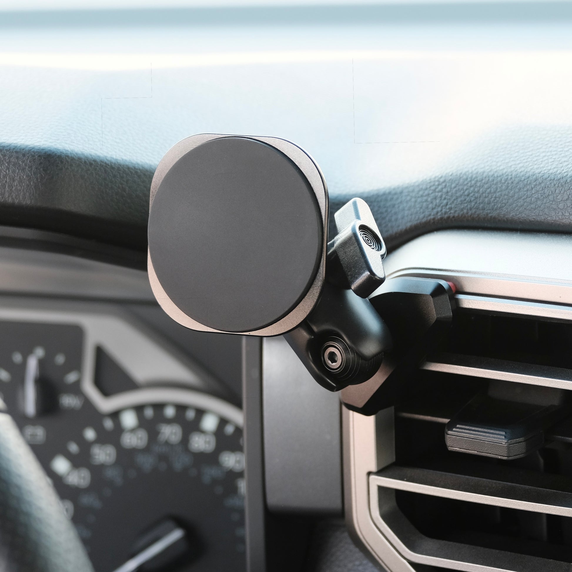 Image of Offroam MagSafe-compatible Phone Mount installed securely in Toyota Tundra 2022-2026 | Sequoia 2023-2026. This premium phone mount installs easily without drilling or glue. High force magnets hold phone on any trail, road, or track. Perfect placement without blocking screens, driver view, or air flow. Fully adjustable positioning.