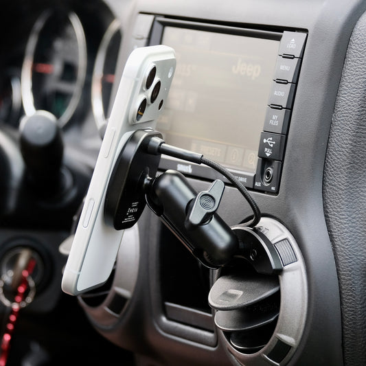 Offroam Qi2 charging mount shown installed in Jeep Wrangler JK 2011-2018 air vent bezel without blocking air flow while holding iPhone with MagSafe securely.