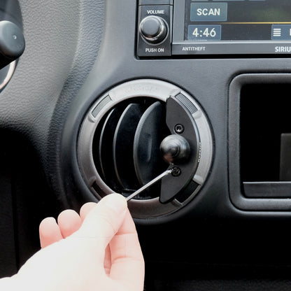 Offroam mounting base with 20mm ball shown being installed with included Allen key in Jeep Wrangler JK 2011-2018 air vent bezel without blocking air flow.