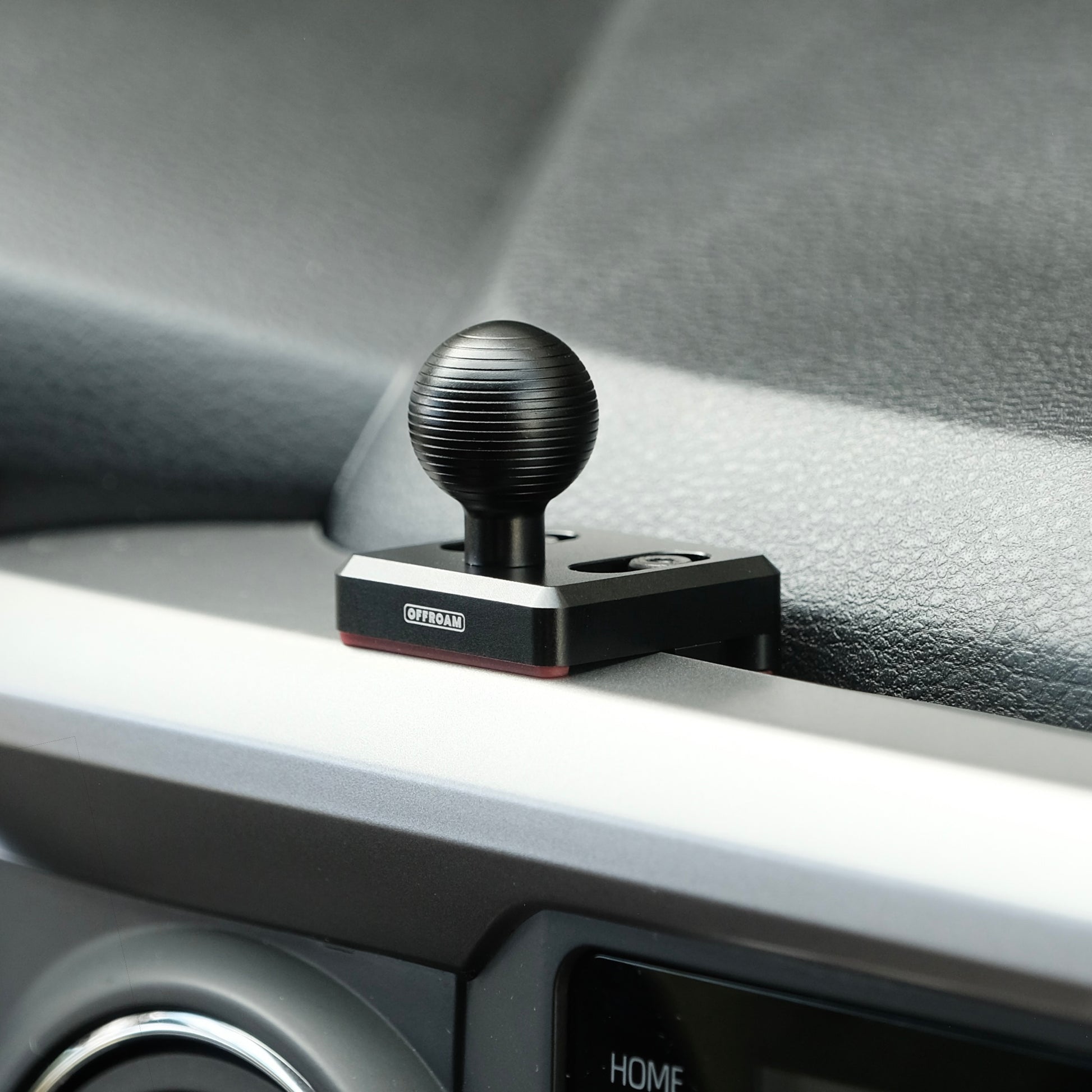 Image of Offroam Mounting Base installed securely in Toyota Tacoma 2016-2023. This premium all metal phone mounting base installs easily without drilling or glue. Perfect placement without blocking screens, driver view, or air flow.