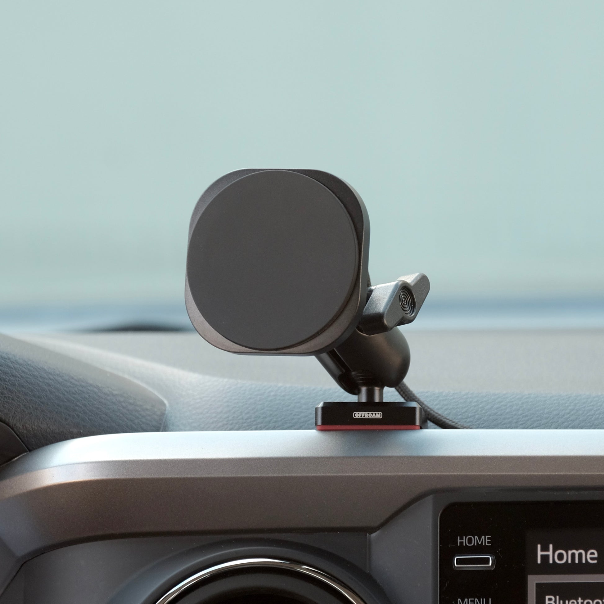 Image of Offroam MagSafe-compatible Phone Mount installed securely in Toyota Tacoma 2016-2023. This premium phone mount installs easily without drilling or glue. High force magnets hold phone on any trail, road, or track. Perfect placement without blocking screens, driver view, or air flow. Fully adjustable positioning.