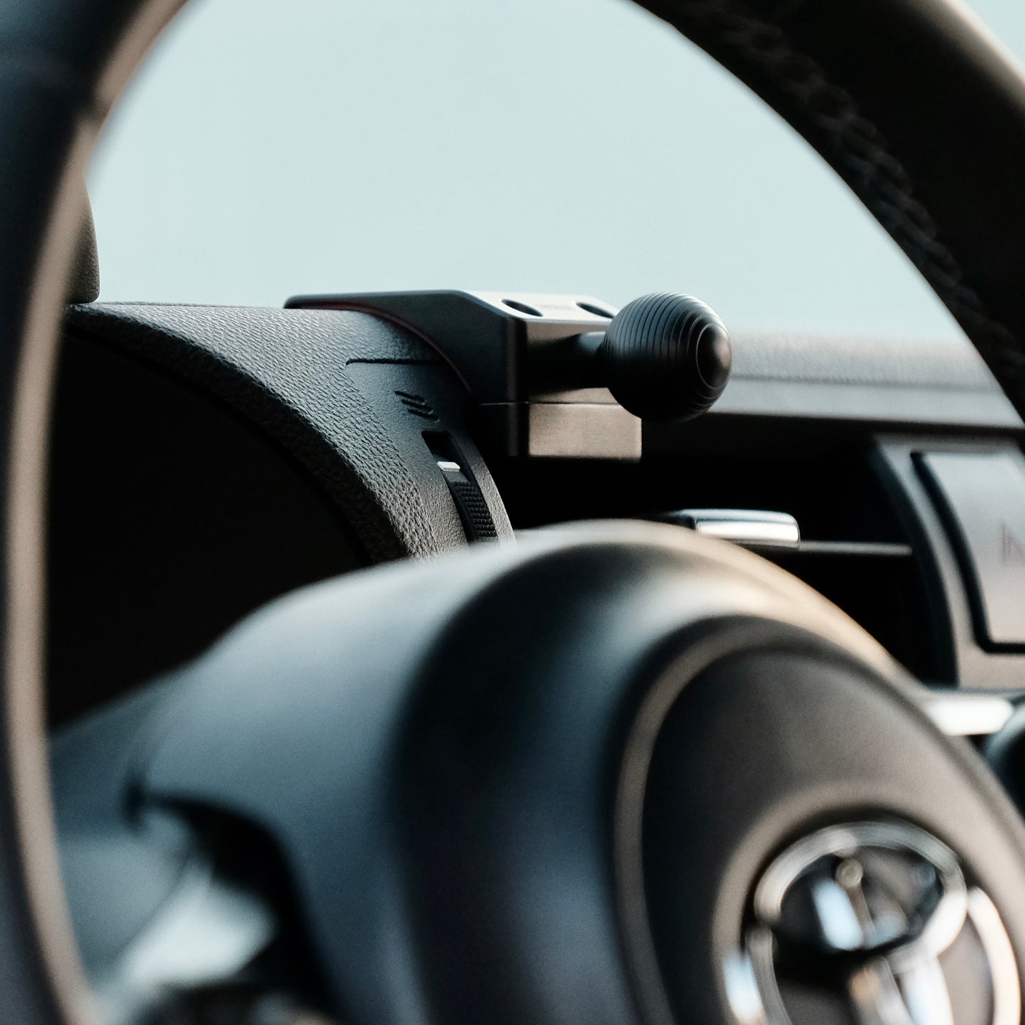 A premium mounting base for Toyota GR86 Subaru BRZ2022-2025 that allows to securely mount phone. Shown being installed in on the vehicle dashboard with easy installation.