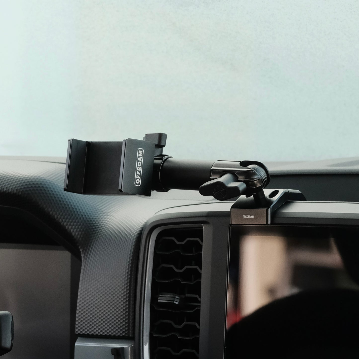 Image of Offroam Phone Mount installed securely in Ford Ranger 2024-2025. This premium phone mount installs easily without drilling or glue. Spring loaded Universal holder for use with any phone. Perfect placement without blocking screens, driver view, or air flow. Fully adjustable positioning.