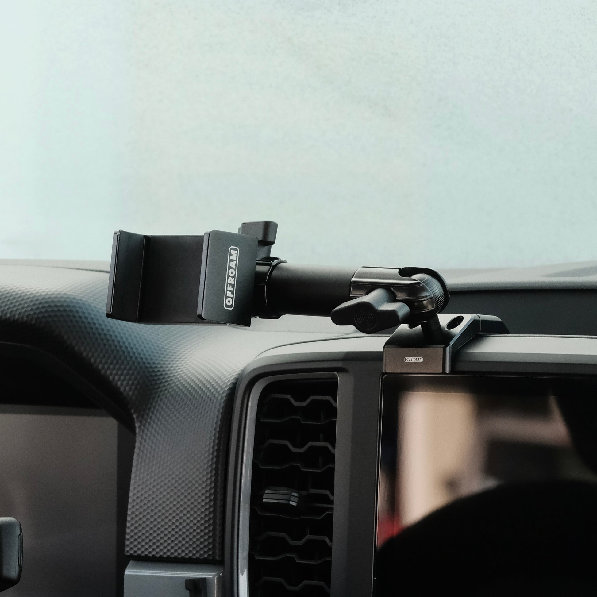 Image of Offroam Phone Mount installed securely in Ford Ranger 2024-2025. This premium phone mount installs easily without drilling or glue. Spring loaded Universal holder for use with any phone. Perfect placement without blocking screens, driver view, or air flow. Fully adjustable positioning.