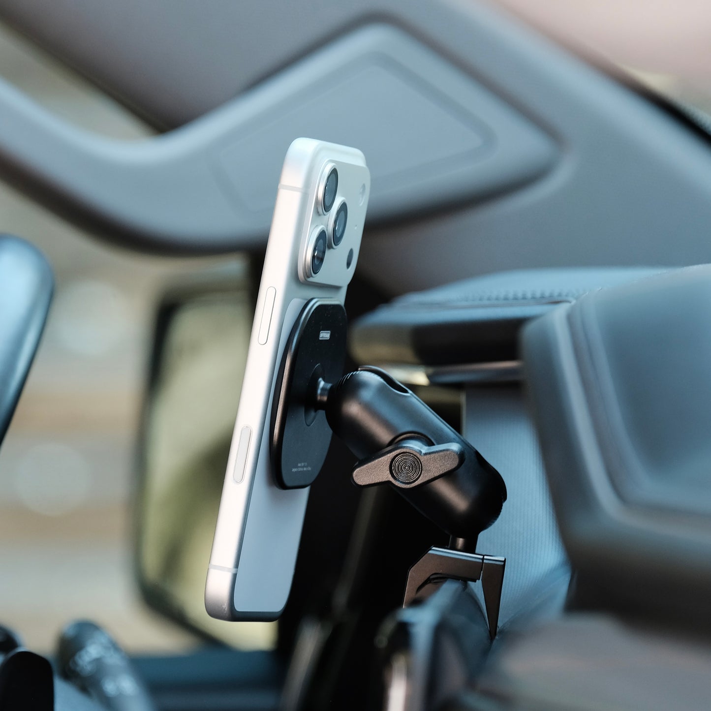 Image of Offroam MagSafe-compatible Phone Mount installed securely in GMC Sierra 1500 2022-2026 | Sierra HD 2024-2026  (AT4, AT4x, Denali, Denali Ultimate). This premium phone mount installs easily without drilling or glue. High force magnets hold phone on any trail, road, or track. Perfect placement without blocking screens, driver view, or air flow. Fully adjustable positioning.