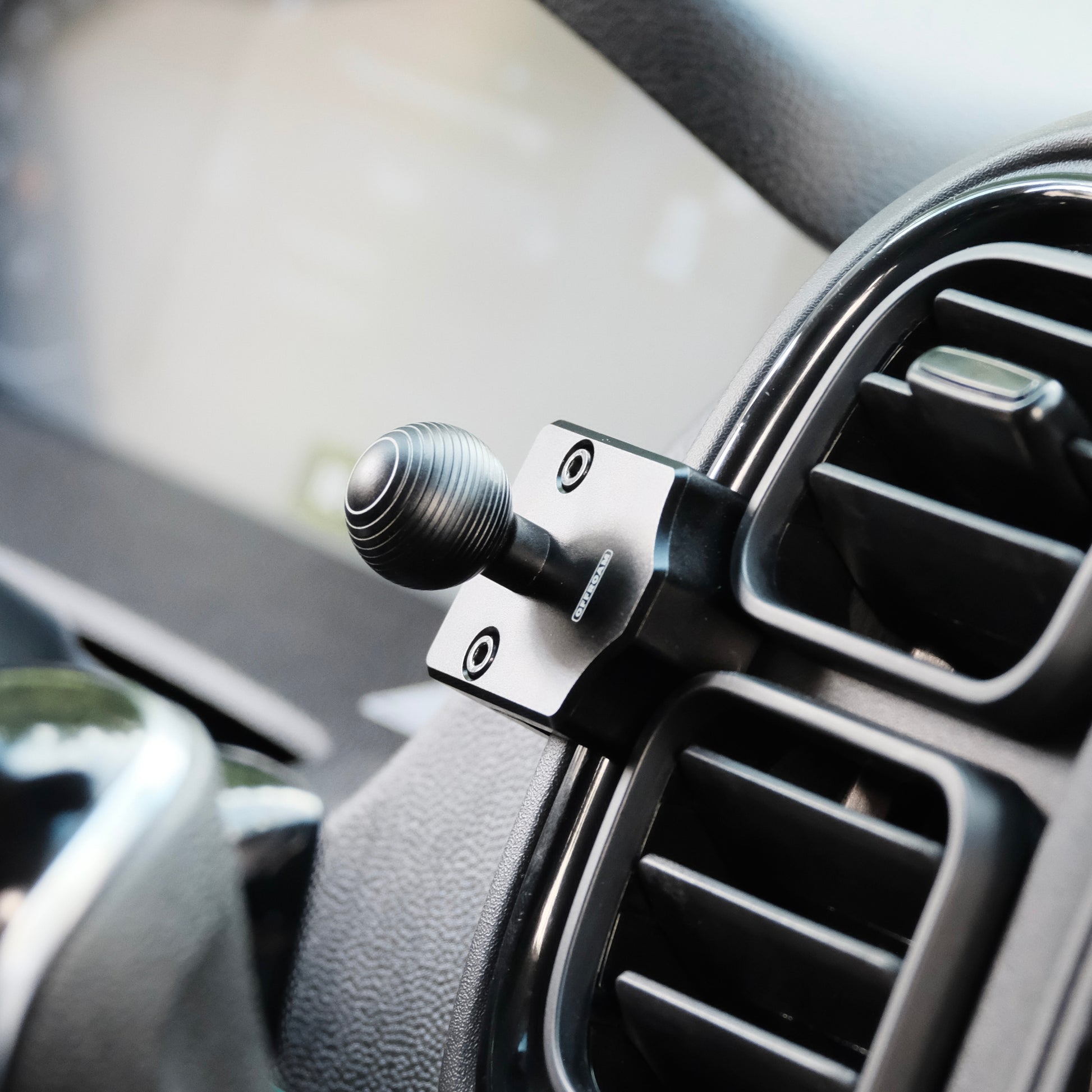 Image of Offroam Mounting Base installed securely in RAM ProMaster 2022-2026. This premium all metal phone mounting base installs easily without drilling or glue. Perfect placement without blocking screens, driver view, or air flow.