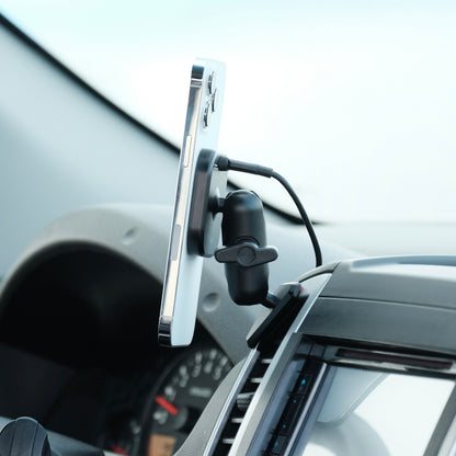 Image of Offroam MagSafe-compatible Qi2 Charging Phone Mount installed securely in Nissan Frontier 2009-2021 | Xterra 2009-2015. This premium phone mount installs easily without drilling or glue. High force magnets hold phone on any trail, road, or track. Perfect placement without blocking screens, driver view, or air flow. Fully adjustable positioning.