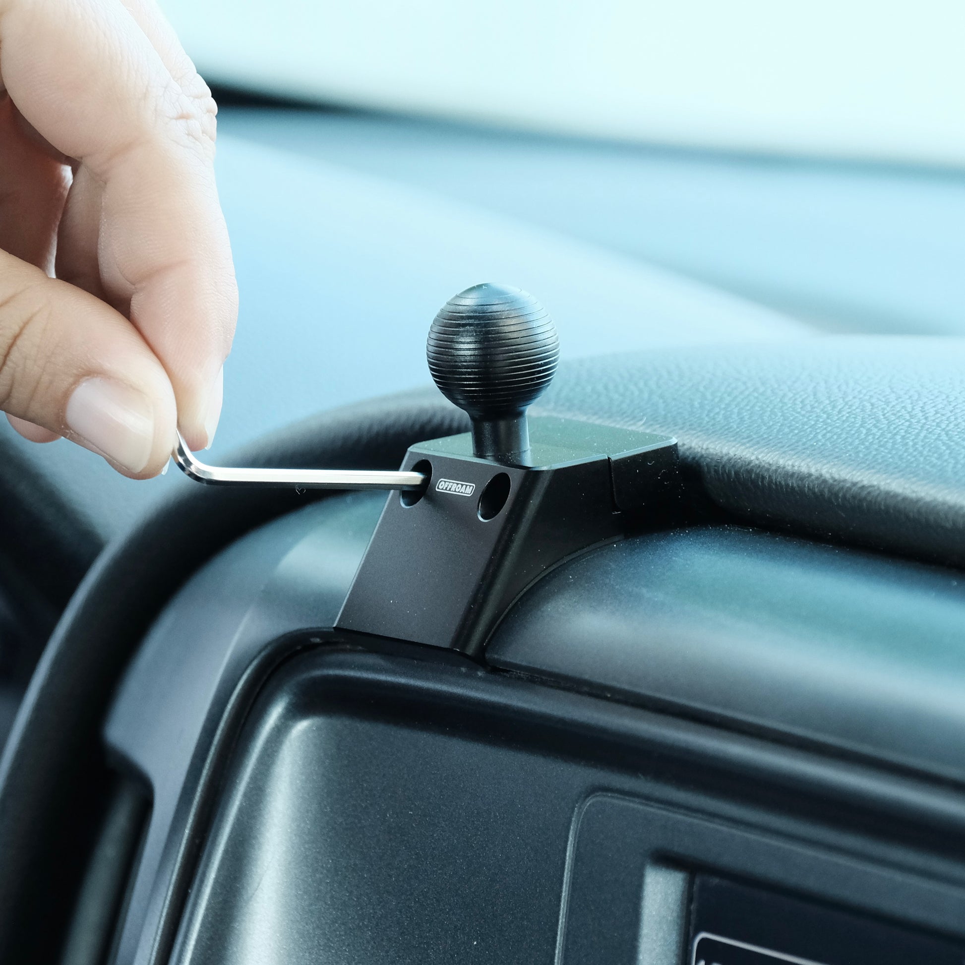 Image of Offroam Mounting Base installation for Chevrolet Silverado 1500 2014-2018 | Silverado HD 2500/3500 2015-2019 | Silverado HD 4500/5500/6500 2019-2026 | GMC Sierra 1500 2014-2018 | Sierra HD 2500/3500 2015-2019. This premium all metal phone mounting base installs easily without drilling or glue. Perfect placement without blocking screens, driver view, or air flow.