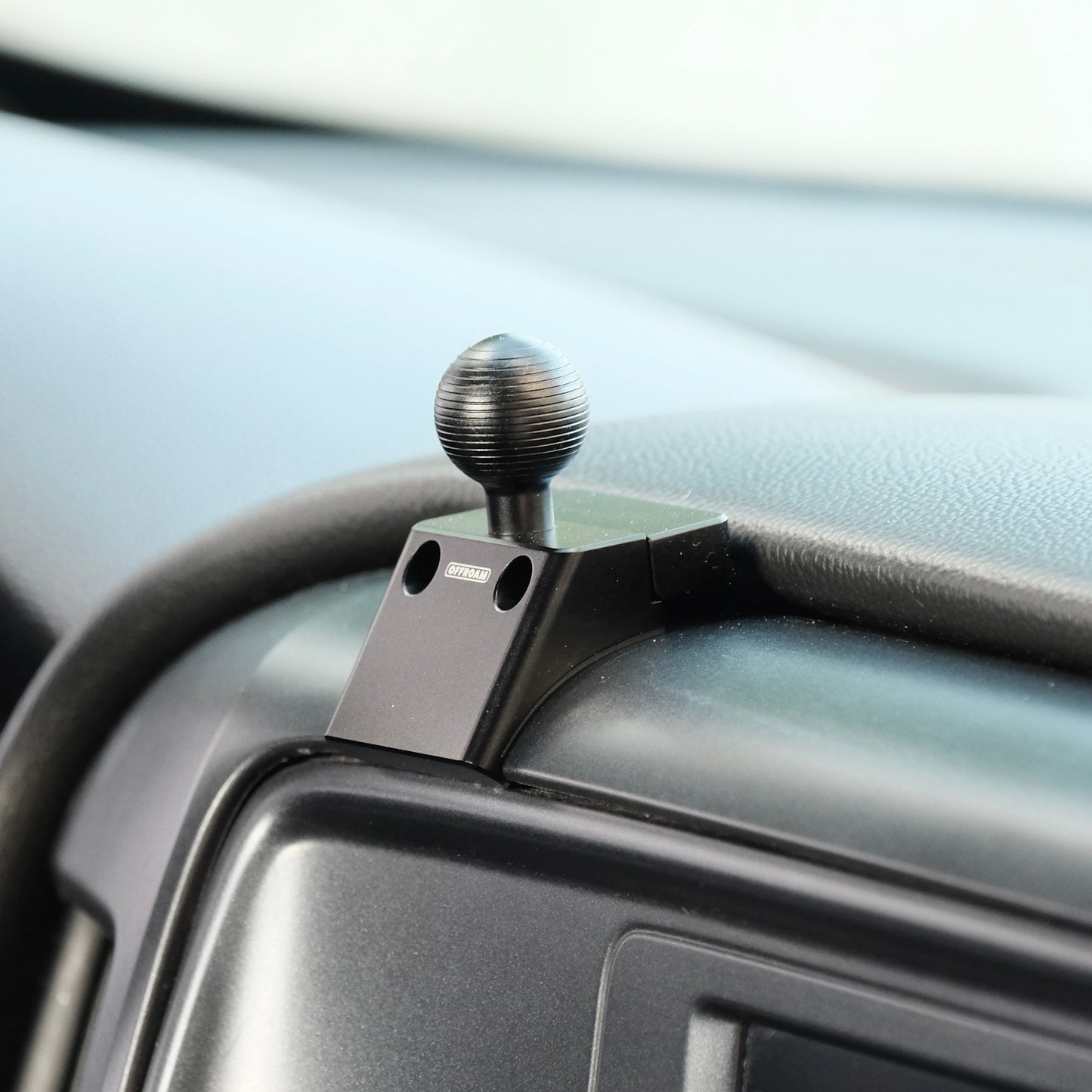 Image of Offroam Mounting Base installed securely in Chevrolet Silverado 1500 2014-2018 | Silverado HD 2500/3500 2015-2019 | Silverado HD 4500/5500/6500 2019-2026 | GMC Sierra 1500 2014-2018 | Sierra HD 2500/3500 2015-2019. This premium all metal phone mounting base installs easily without drilling or glue. Perfect placement without blocking screens, driver view, or air flow.