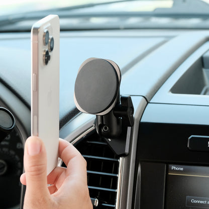 Image of Offroam MagSafe-compatible Phone Mount installed securely in Ford F-150 2015-2020 | Super Duty 2017-2021 & 2022 (XL and XLT) | Expedition 2018-2021. This premium phone mount installs easily without drilling or glue. High force magnets hold phone on any trail, road, or track. Perfect placement without blocking screens, driver view, or air flow. Fully adjustable positioning.