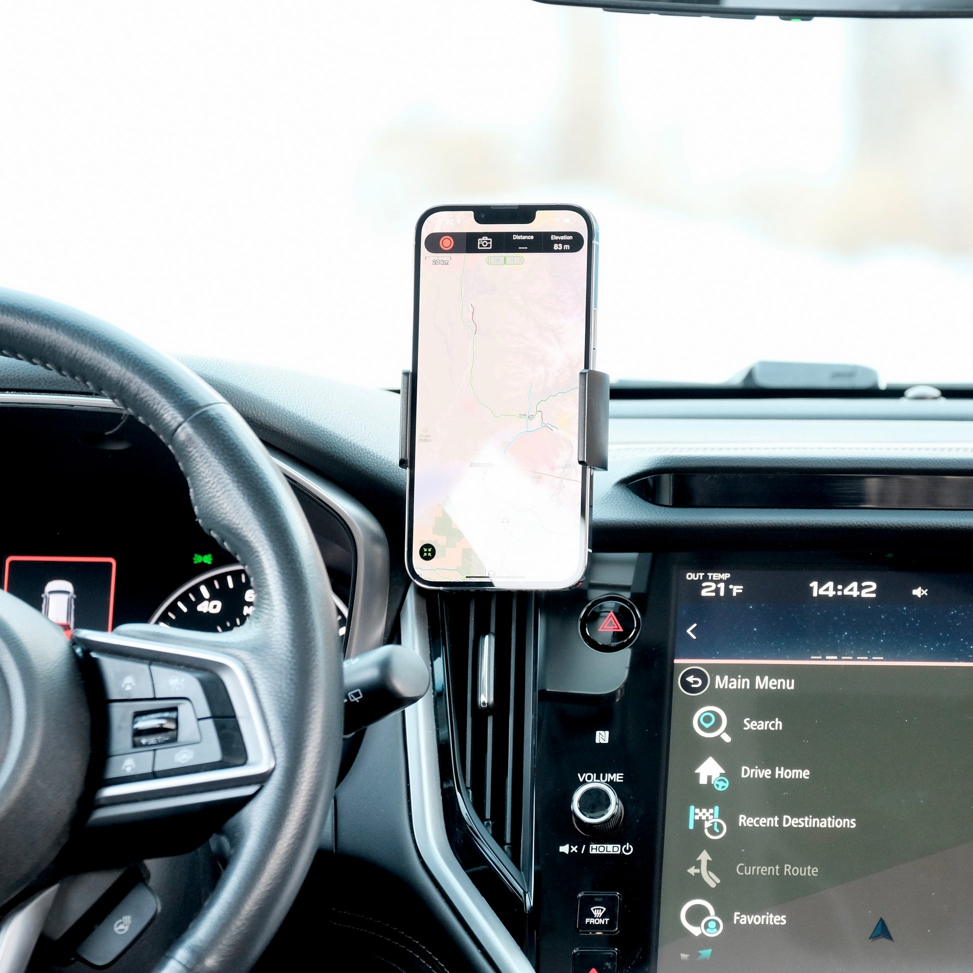 Offroam phone holder in Subaru Outback 2020-2024 or Subaru Legacy 2020-2024, securely holding large phone with spring loaded holder, adjustable 360-degree swivel arm, and rugged all-metal construction, positioned in a perfect spot without blocking the view, controls, or airflow. 