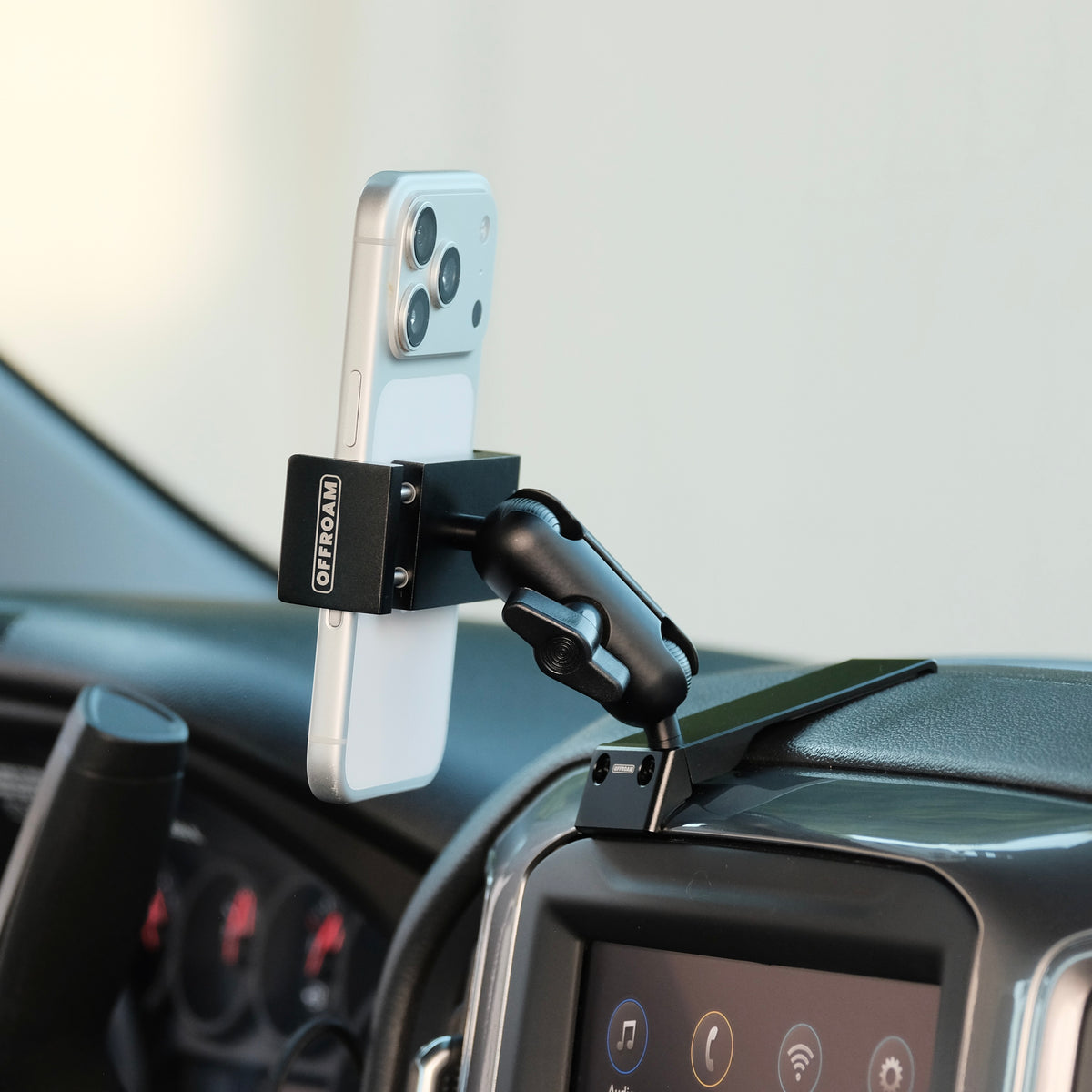 Image of Offroam Phone Mount installed securely in Chevrolet Silverado 2019-2026 | Silverado HD 2020-2026 & GMC Sierra 1500 2019-2026 | Sierra HD 2020-2026 with 7-in.|8-in. display. This premium phone mount installs easily without drilling or glue. Spring loaded Universal holder for use with any phone. Perfect placement without blocking screens, driver view, or air flow. Fully adjustable positioning.