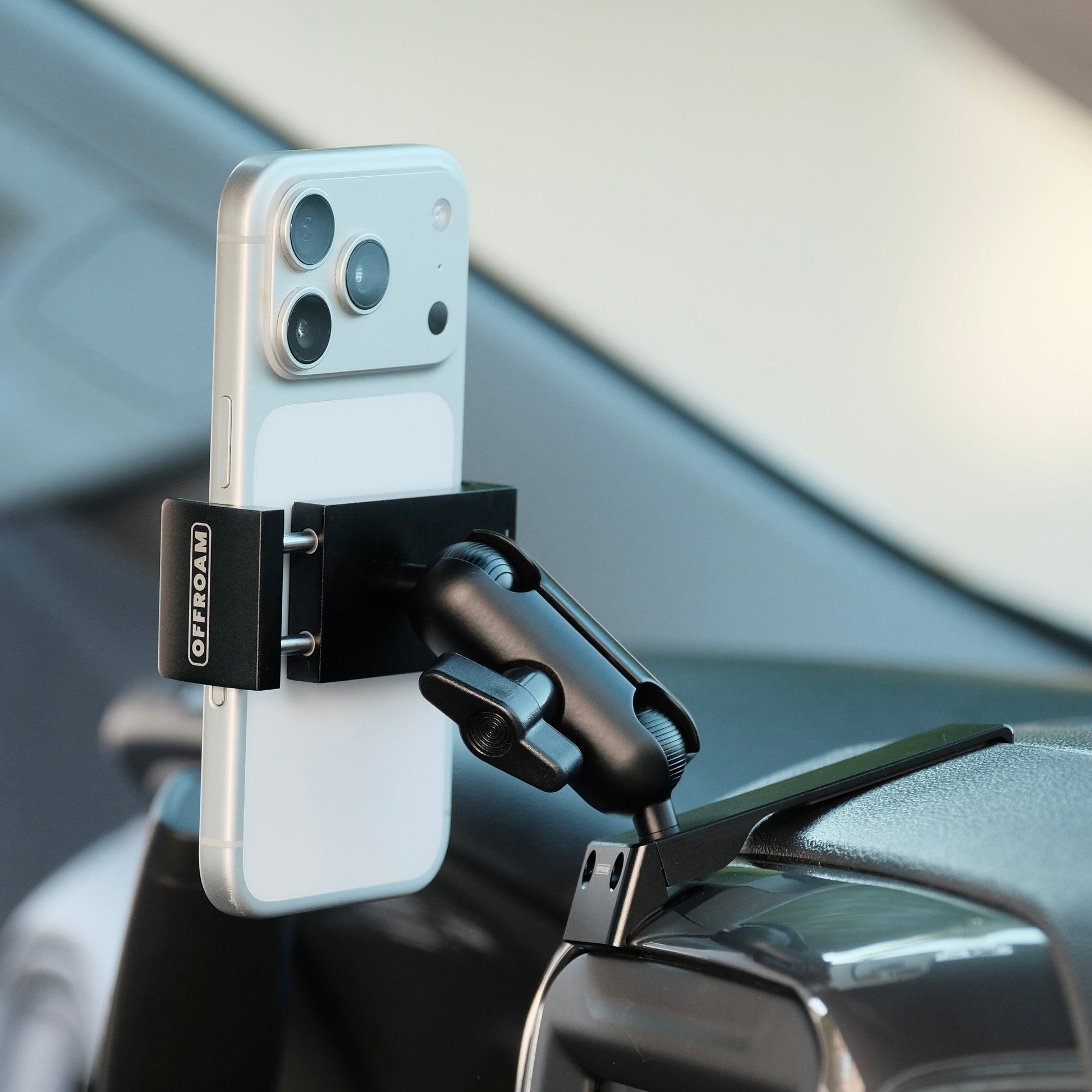 Image of Offroam Phone Mount installed securely in Chevrolet Silverado 2019-2026 | Silverado HD 2020-2026 & GMC Sierra 1500 2019-2026 | Sierra HD 2020-2026 with 7-in.|8-in. display. This premium phone mount installs easily without drilling or glue. Spring loaded Universal holder for use with any phone. Perfect placement without blocking screens, driver view, or air flow. Fully adjustable positioning.