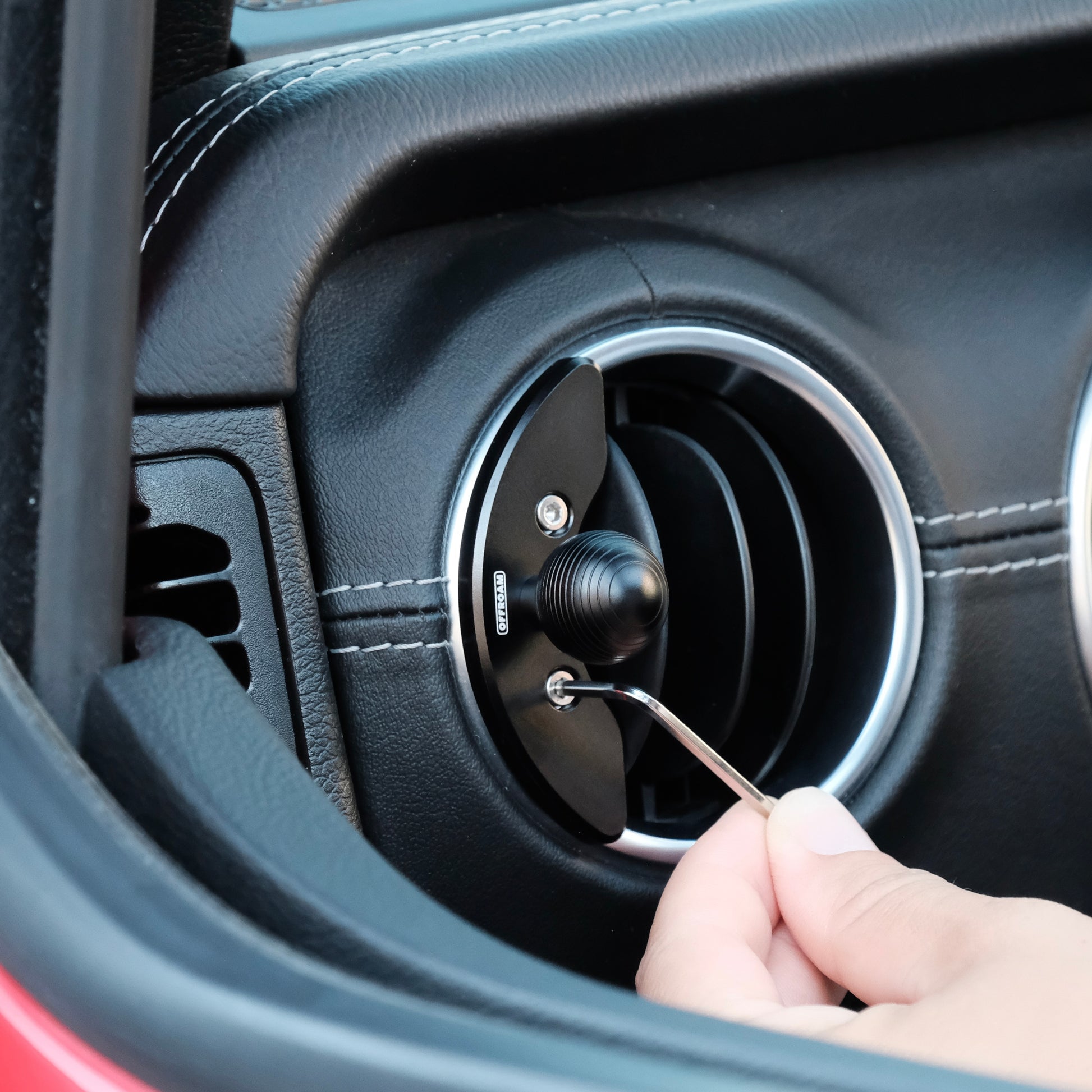 Image of Offroam Mounting Base installed securely in Jeep Wrangler 2018-2023 | Gladiator 2019-2023. This premium all metal phone mounting base installs easily without drilling or glue. Perfect placement without blocking screens, driver view, or air flow.