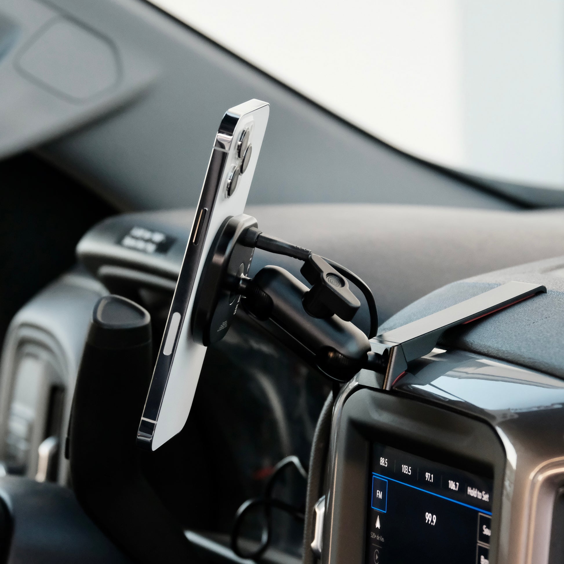 Image of Offroam MagSafe-compatible Phone Mount installed securely in Chevrolet Silverado 2019-2024 | Silverado HD 2020-2024 and GMC Sierra 1500 2019-2021 | Sierra HD 2020-2023 with 7-in.|8-in. display. This premium phone mount installs easily without drilling or glue. High force magnets hold phone on any trail, road, or track. Perfect placement without blocking screens, driver view, or air flow. Fully adjustable positioning.