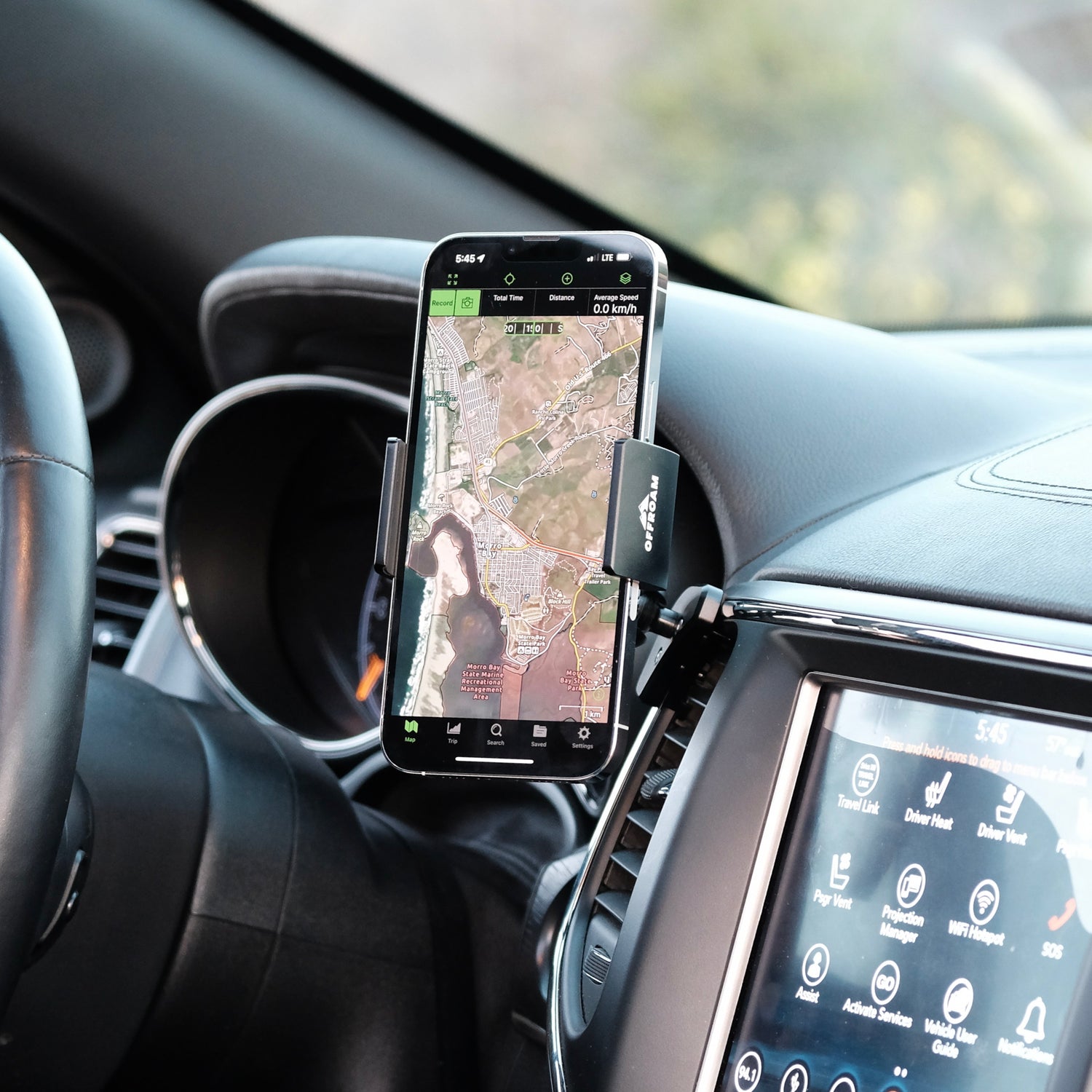 Image of Offroam Phone Mount installed securely in Jeep Grand Cherokee WK2 2014-2022. This premium phone mount installs easily without drilling or glue. Spring loaded Universal holder for use with any phone. Perfect placement without blocking screens, driver view, or air flow. Fully adjustable positioning.