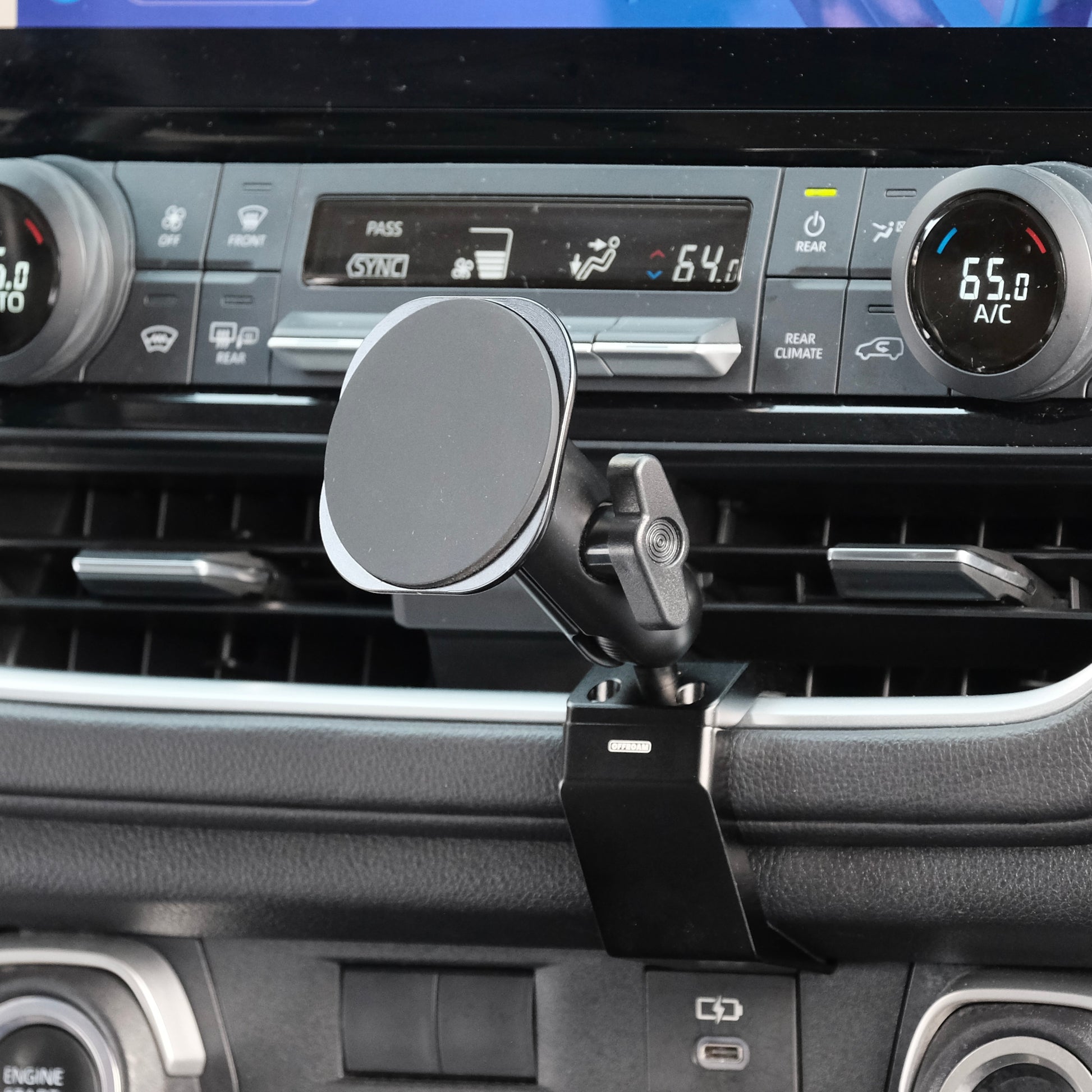 Image of Offroam MagSafe-compatible Phone Mount installed securely in Toyota Grand Highlander 2024-2026. This premium phone mount installs easily without drilling or glue. High force magnets hold phone on any trail, road, or track. Perfect placement without blocking screens, driver view, or air flow. Fully adjustable positioning.