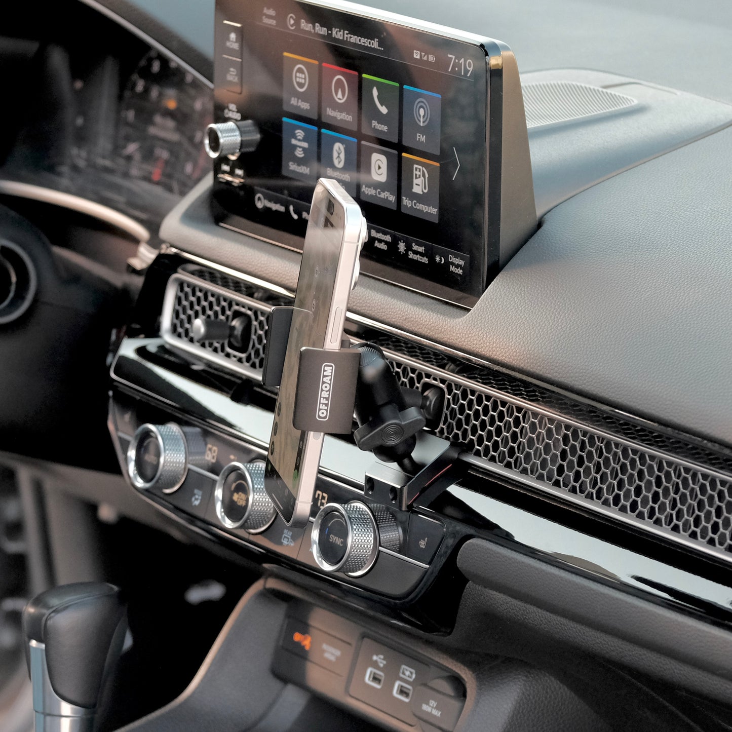 A phone mount for Honda Civic & CR-V 2023-2025 installed securely to the dashboard, all-metal design uses existing features in the vehicle without adhesives or drilling. Universal fit and secure hold on any road.