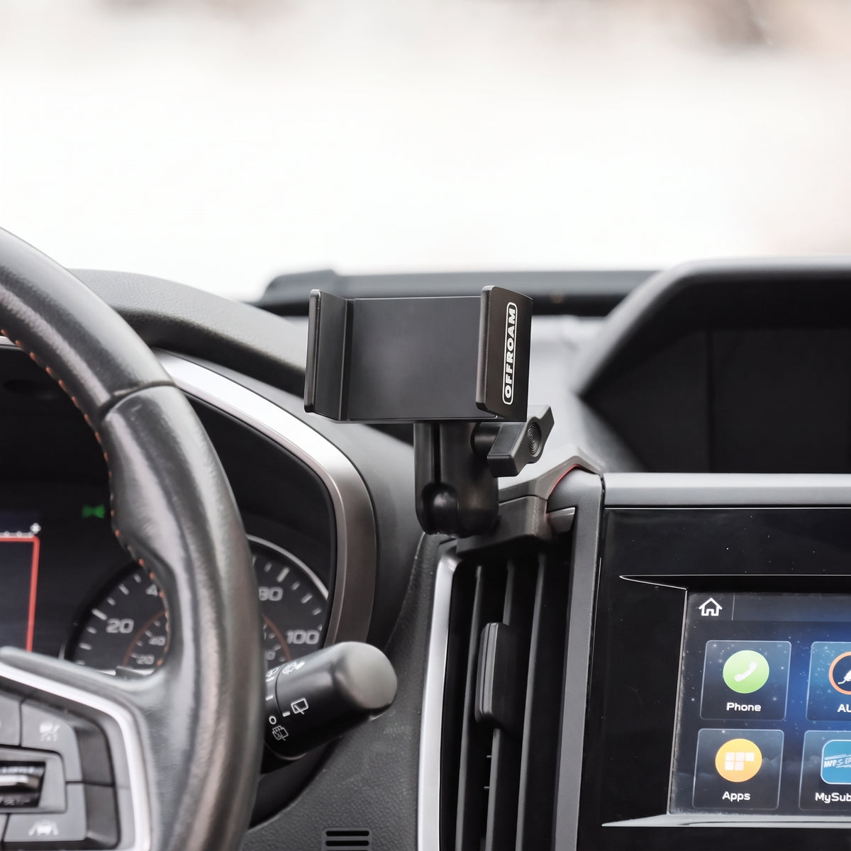 Image of Offroam Phone Mount installed securely in Subaru Crosstrek 2018-2023 | Forester 2019-2024| Impreza 2017-2023. This premium phone mount installs easily without drilling or glue. Spring loaded Universal holder for use with any phone. Perfect placement without blocking screens, driver view, or air flow. Fully adjustable positioning.