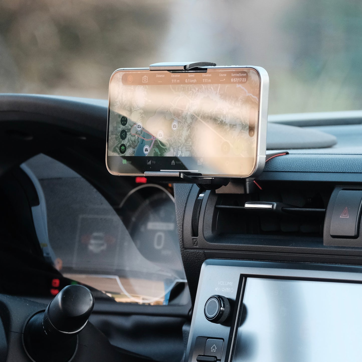 Offroam phone mount installed securely in Toyota GR86 or Subaru BRZ 2022-2025 near display screen is a premium accessory. Installs easily into existing features without drilling or glue. Perfect placement above air vent without blocking the screen, windshield or air flow. Fully adjustable positioning. Phone shown in landscape position.