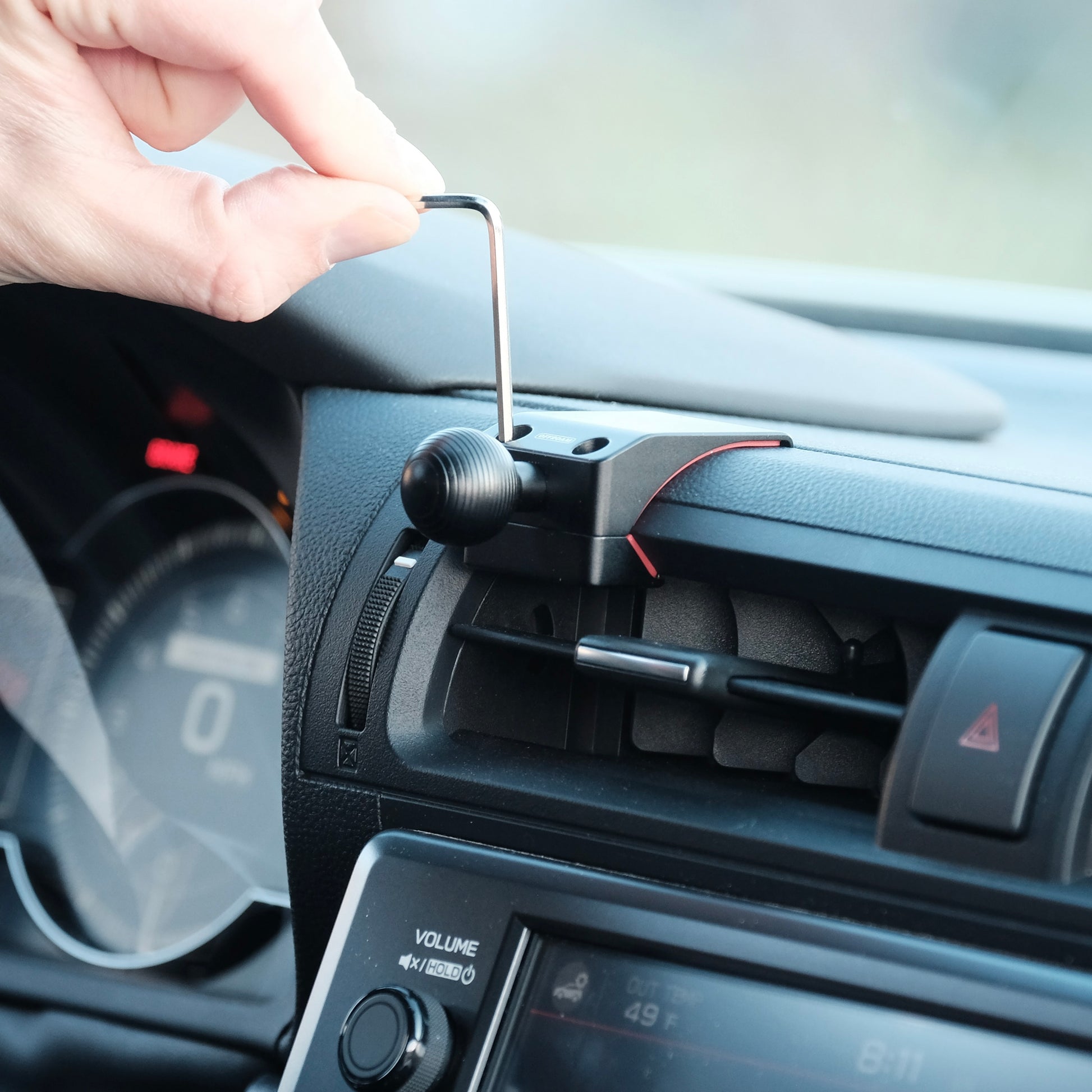 A premium mounting base for Toyota GR86 Subaru BRZ2022-2025 that allows to securely mount phone. Shown being installed in on the vehicle dashboard with easy installation.