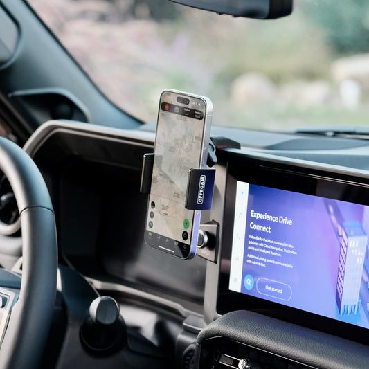 An Offroam phone mount installed securely in Toyota Land Cruiser 2024-2025 near display screen is a premium accessory. Installs easily into existing features without drilling or glue. Perfect placement above the start button without blocking the screen, windshield or air flow. Fully adjustable positioning.