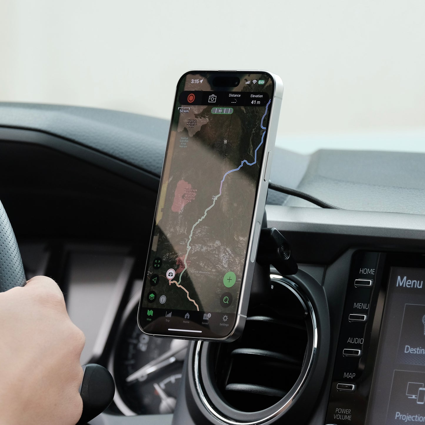 Offroam Qi2 Charging Phone mount attached securely to Toyota Tacoma 2016-2023 or Toyota Tundra 2014-2021 with vehicle-specific mounting base and a coupling arm. Showing a secure hold, fast charge and perfect placement without blocking the airflow.