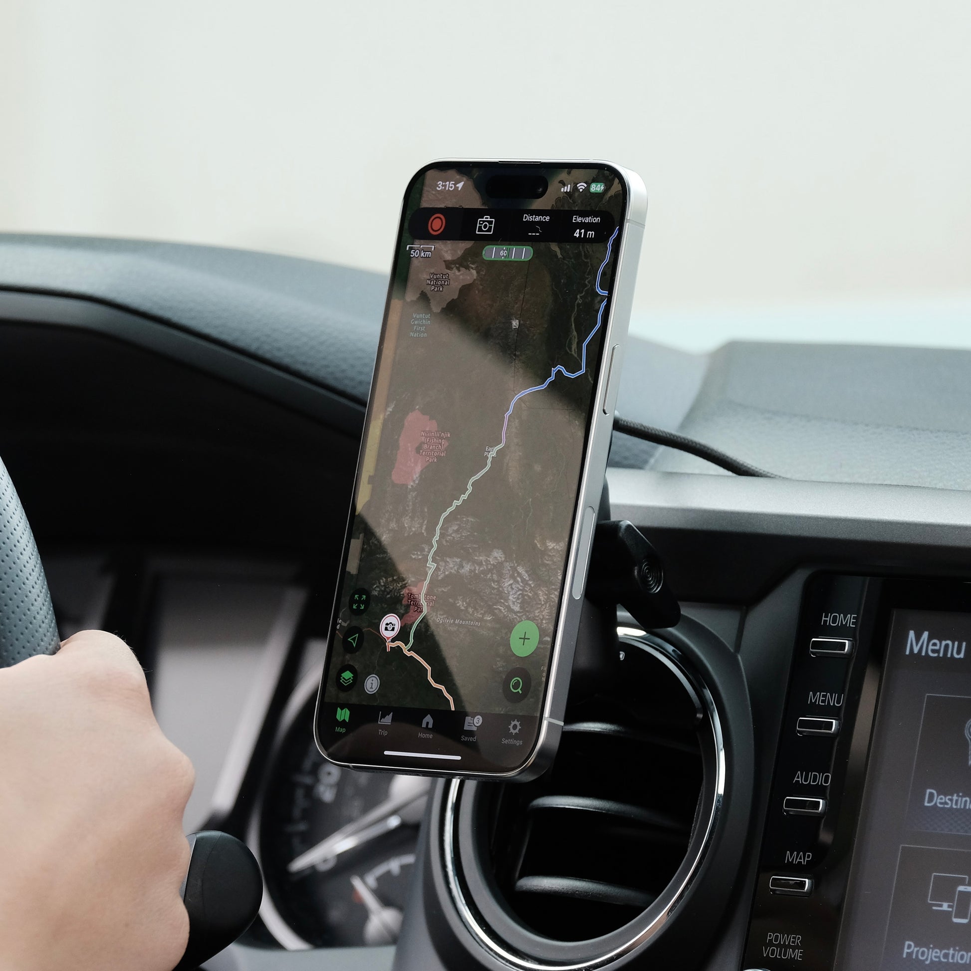 Offroam Qi2 Charging Phone mount attached securely to Toyota Tacoma 2016-2023 or Toyota Tundra 2014-2021 with vehicle-specific mounting base and a coupling arm. Showing a secure hold, fast charge and perfect placement without blocking the airflow.