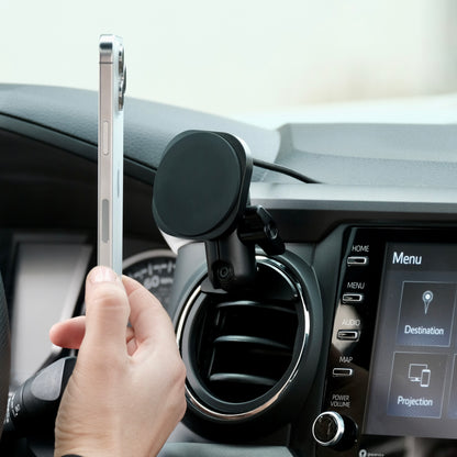 Offroam phone holder attached securely to Toyota Tacoma 2016-2023 air vent bezel with integrated 20mm ball mount interface. Showing Offroam articulating arm and a Qi2 fast charging MagSafe-compatible holder with strong magnets.