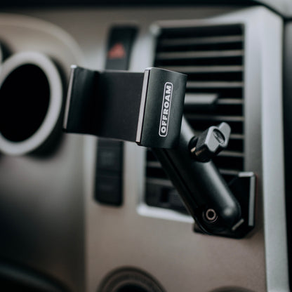 A close up photo of the Offroam system installed in the 2nd gen Tundra 2007-2013 showing a secure mounting base, a medium arm and a universal phone holder. Image taken in @desktoglory's vehicle